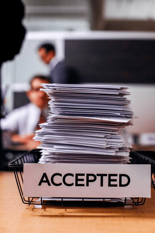 A stack of accepted USCIS applications with certified translations