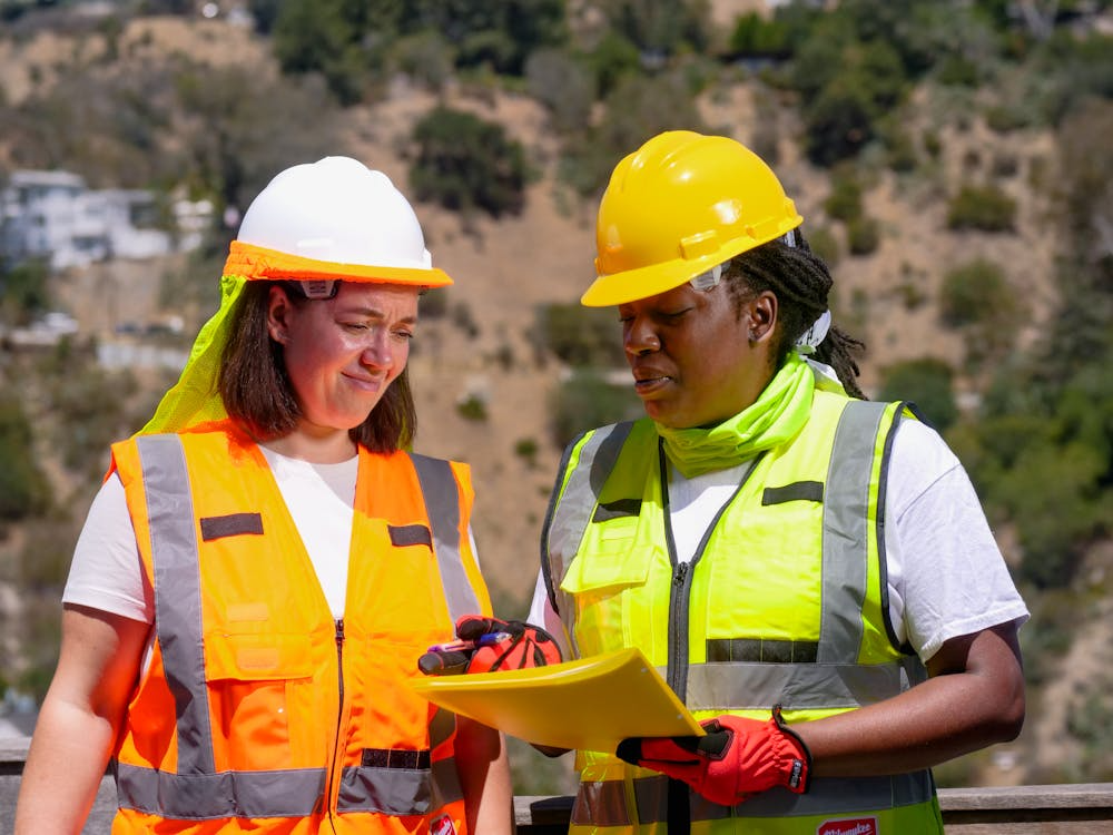two construction workers standing outdoors
