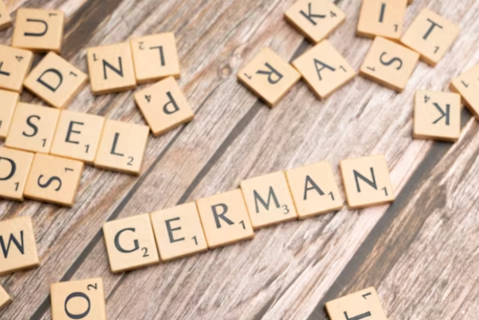 This image shows a word ‘German’ written with scrabble letters.