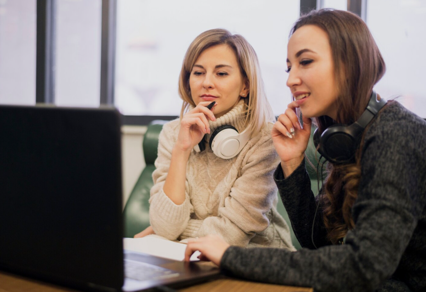 Certified translators comparing original and translated recommendation letters on a laptop 