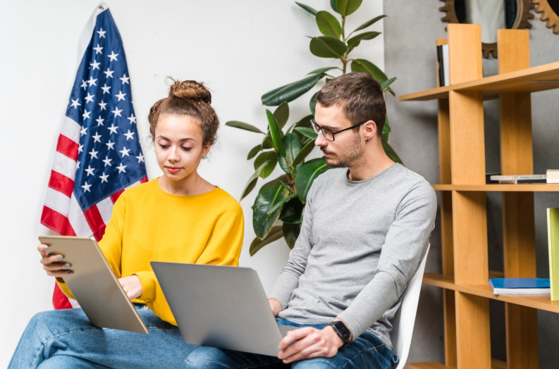 Multiple translators collaborating on a user agreement translation project using a laptop.